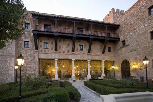 a large building with a balcony on top of it at Parador de Siguenza in Sigüenza