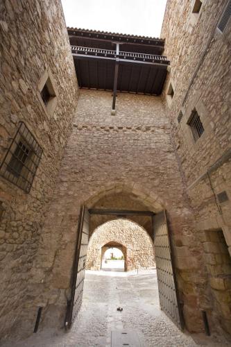 an entrance to a building with an archway at Parador de Siguenza in Sigüenza