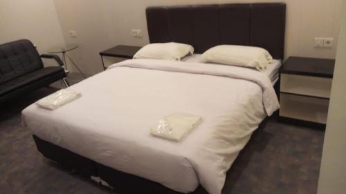 Кровать или кровати в номере Puncak Budget Hotel