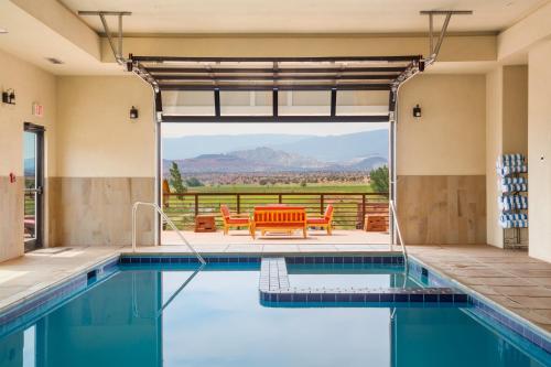 a pool in a house with a view of the mountains at Red Sands Hotel in Torrey