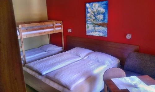 a bedroom with two bunk beds and a table at Apartmán 401 C - Veľká Lomnica in Veľká Lomnica