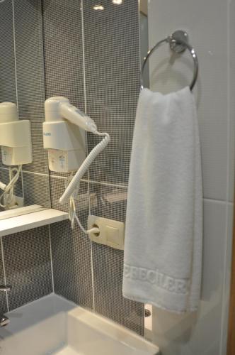 a white towel hanging on a towel rack in a bathroom at Cebeciler Hotel in Trabzon