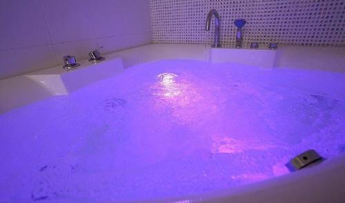 een paars bad met een roze licht erin bij Together B&B in Hualien
