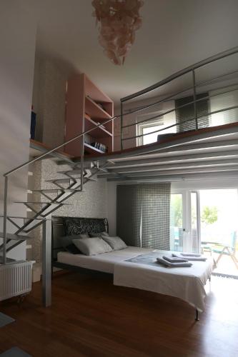 a bedroom with a bed with a metal staircase at Thimari Sports & Spa with private pool and jacuzzi in Sounio