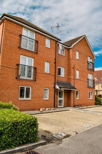 a red brick building with a parking lot at Welcome Home in Royston