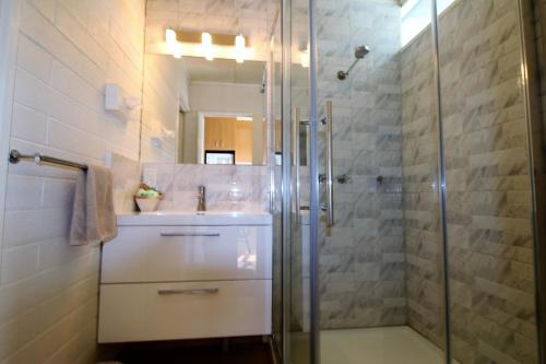 a bathroom with a shower and a sink at Cobram Colonial Motor Inn in Cobram