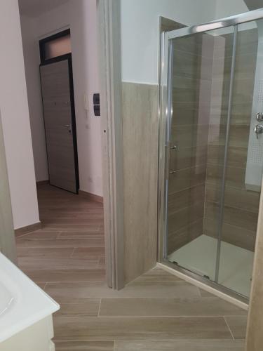 a shower with a glass door in a bathroom at Residenza Lumière in Termoli
