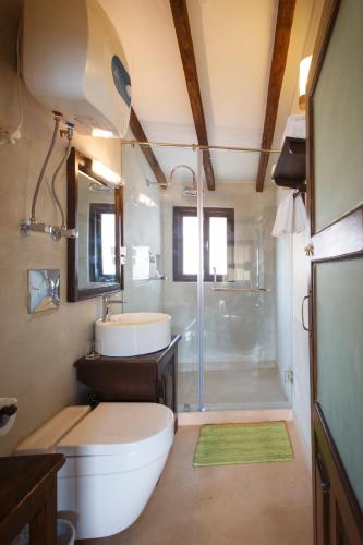 a bathroom with a toilet and a sink and a shower at Hotel Patan House in Pātan