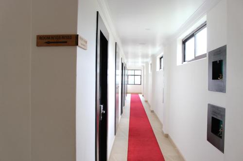 a corridor with a red carpet in a hallway at Tuki Resort Pokhara in Pokhara