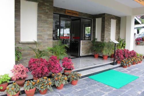 a group of flowers in front of a building at Tuki Resort Pokhara in Pokhara