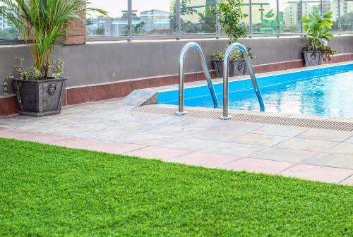 a swimming pool with a ramp to the side of a building at Highlands Suites Hotel Apartments in Nairobi