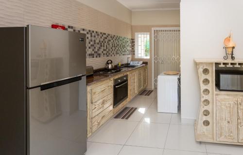 a kitchen with a stainless steel refrigerator at Beau Vallon Villa Chalets in Beau Vallon