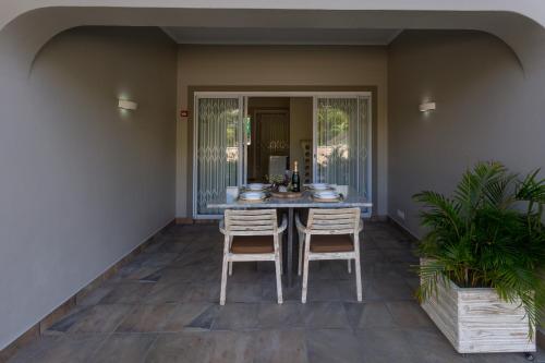 a patio with a table and two stools at Beau Vallon Villa Chalets in Beau Vallon