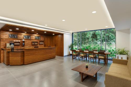 a living room with a table and chairs at Ginger Mumbai, Andheri in Mumbai