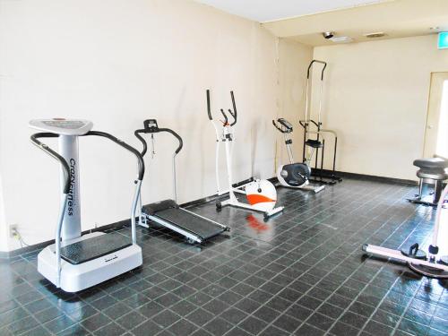 a gym with several exercise equipment in a room at kinugawaonsen Fukumatsu in Nikko