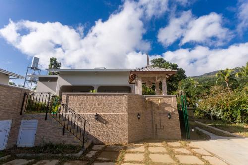 a brick house with a gazebo at Beau Vallon Villa Chalets in Beau Vallon