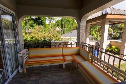 a porch with a bench on a balcony at Beau Vallon Villa Chalets in Beau Vallon