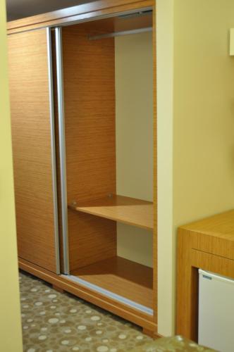 a closet with a wooden door and wooden shelves at Cebeciler Hotel in Trabzon