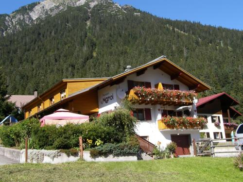a building with flower boxes on the side of it at Hotel Maroi in Wald am Arlberg