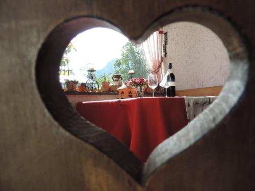 a table with a red table cloth and wine glasses at Hotel Maroi in Wald am Arlberg