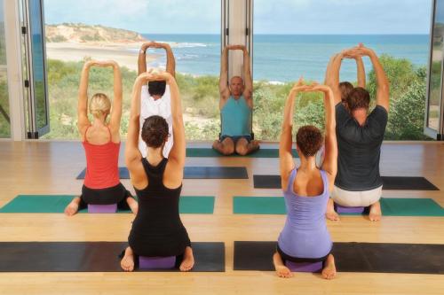 a group of people in a yoga class at Eco Beach Wilderness Retreat in Broome
