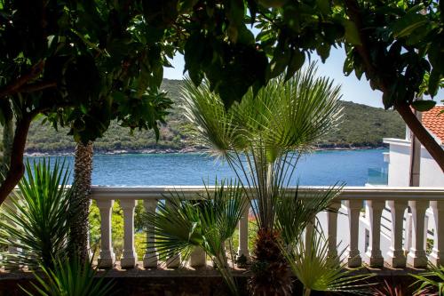 a view of the water from a balcony with trees at Sea Oasis Apartments - Milosevic in Kotor