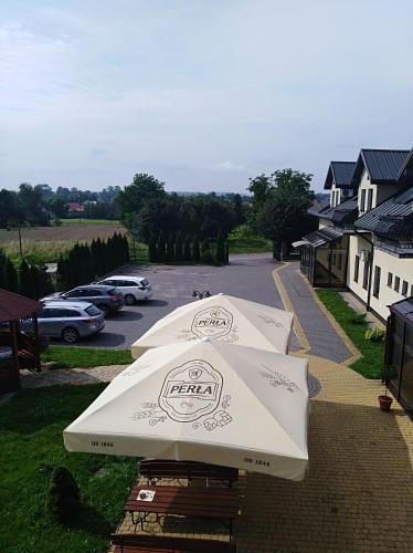 a large white umbrella sitting on a patio at Hotel Platinum Hrubieszów in Hrubieszów