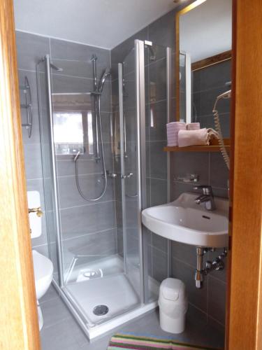 a bathroom with a shower and a sink at Hotel Maroi in Wald am Arlberg