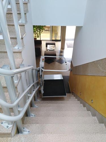 a staircase in a building with a stair case at Hotel Platinum Hrubieszów in Hrubieszów