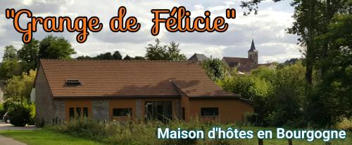 a picture of a house with a church in the background at la Grange de Félicie in Charrey-sur-Saône