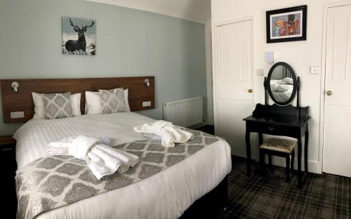 Postel nebo postele na pokoji v ubytování St Ives Boutique Hotel