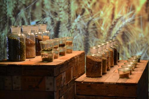 a row of jars filled with spices on top of wooden crates at Hotel Brouwerij Het Anker in Mechelen
