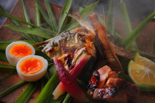 a plate of food with a fish and eggs at Yufuin Bath Satoyamasafu in Yufu