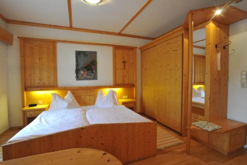 a bedroom with a large wooden bed in a room at Gasthof Kirchenwirt in Lackenhof