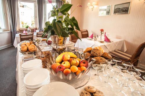 a long table with a bunch of food on it at Hotel Rosenau in Bad Harzburg