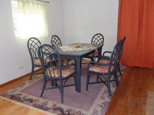 a dining room with a table and chairs and a window at Ferienhaus am Reitbauernhof Luckyranch in Mellach