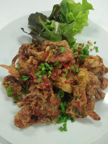 a white plate of food with a salad on it at Green Ville Laguna Hotel in Sung Noen