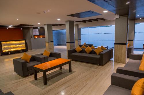 a lobby with couches and a table and a couch at Ginger Ahmedabad, Satellite in Ahmedabad