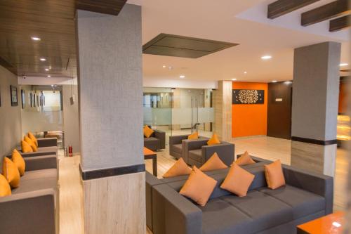 a living room with a couch and orange pillows at Ginger Ahmedabad, Satellite in Ahmedabad