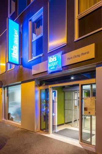 a building with a tds murder sign on it at ibis budget Paris Clichy Mairie in Clichy