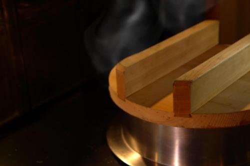 a close up of a pot with smoke coming at Takahan in Yuzawa