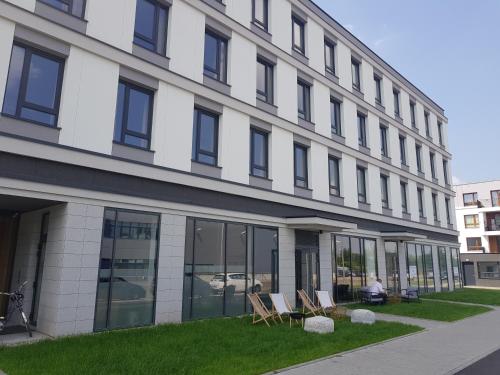 a building with chairs in front of it at Arche Hotel Poloneza in Warsaw