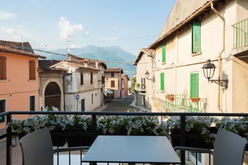 a balcony with a table and chairs on a street at La Bellavita del Garda Luxury Apartments in San Felice del Benaco