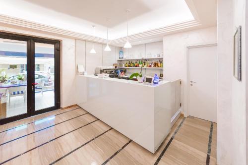 a kitchen with white cabinets and a counter top at Hotel Universal in Riccione