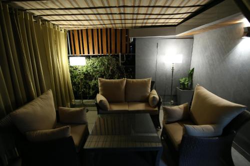 a living room with two chairs and a table at Hotel City Heart Premium in Chandīgarh