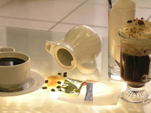a table with a cup of coffee and a drink at Athens City Hotel in Athens