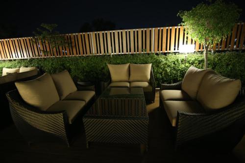 a patio with chairs and a table at night at Hotel City Heart Premium in Chandīgarh