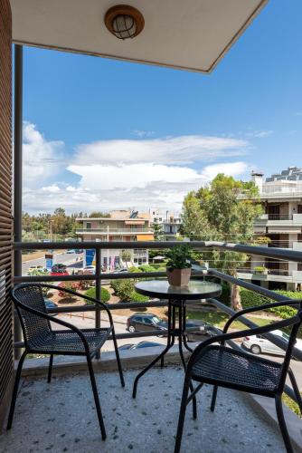 a balcony with a table and two chairs and a view at Minavra Hotel in Athens