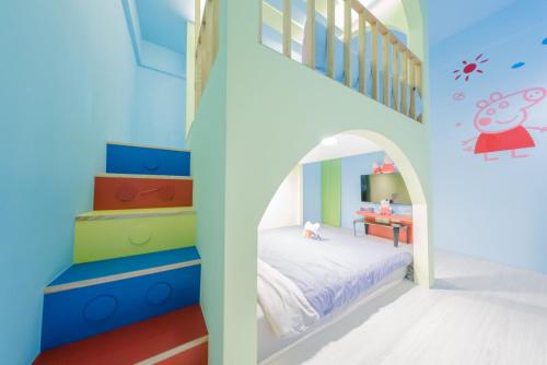 a childs room with a bunk bed and a staircase at Happiness Pediatrics in Xiaoliuqiu