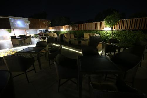 a group of chairs and tables on a patio at night at Hotel City Heart Premium in Chandīgarh